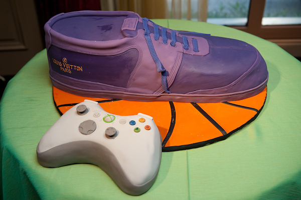 fun and hillarious groom's cake - green cake with with purple Louis Vuitton shoe on top of flattened basketball and an Xbox controller - photo by Houston based wedding photographer Adam Nyholt